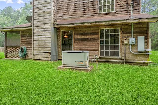 back of property featuring a lawn