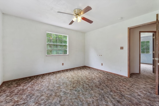 empty room with ceiling fan and carpet floors