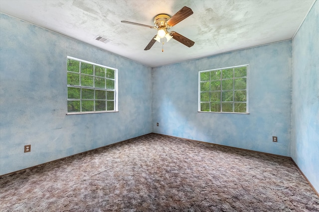 carpeted spare room with ceiling fan