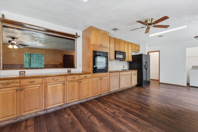 kitchen with washer / dryer, black appliances, ceiling fan, and dark hardwood / wood-style floors