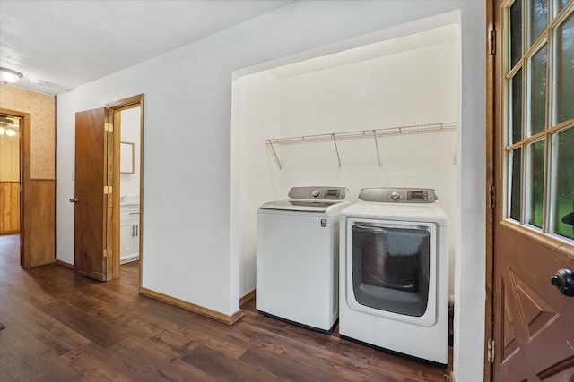 washroom with dark wood-type flooring and washer and clothes dryer