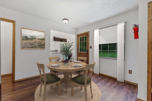 dining area with dark hardwood / wood-style floors