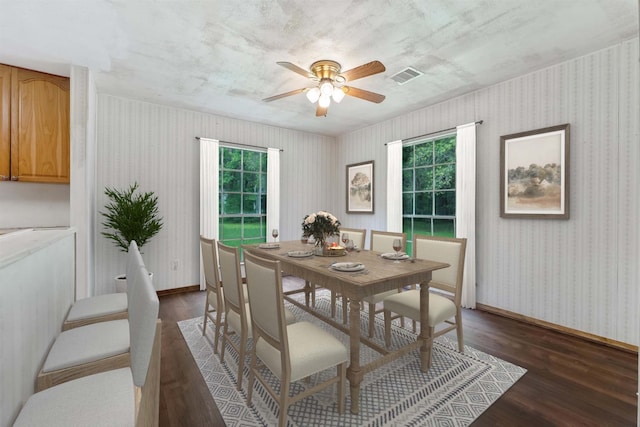 dining area featuring dark wood-type flooring and ceiling fan