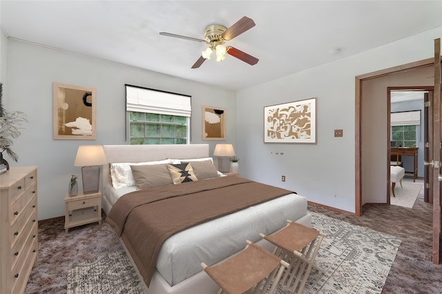 carpeted bedroom featuring ceiling fan and multiple windows