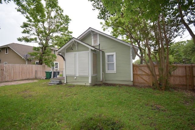 rear view of property with a yard