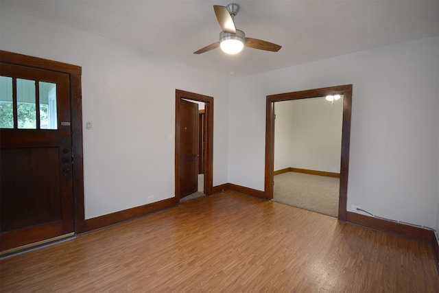 empty room with hardwood / wood-style flooring and ceiling fan