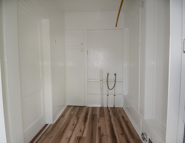 clothes washing area featuring hardwood / wood-style flooring