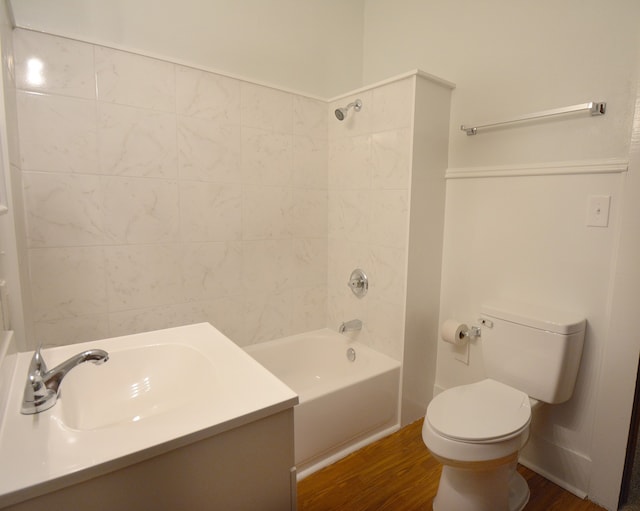 full bathroom featuring wood-type flooring, vanity, toilet, and tiled shower / bath combo