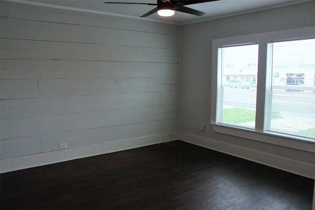 spare room featuring ceiling fan and dark hardwood / wood-style floors