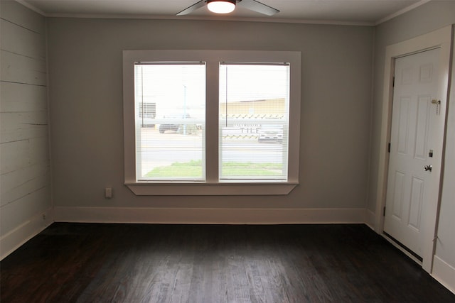 empty room with dark hardwood / wood-style flooring and ceiling fan