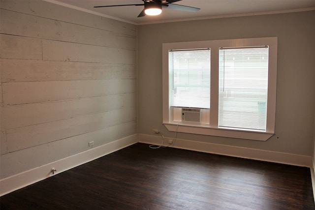 spare room with ceiling fan, dark wood-type flooring, and crown molding