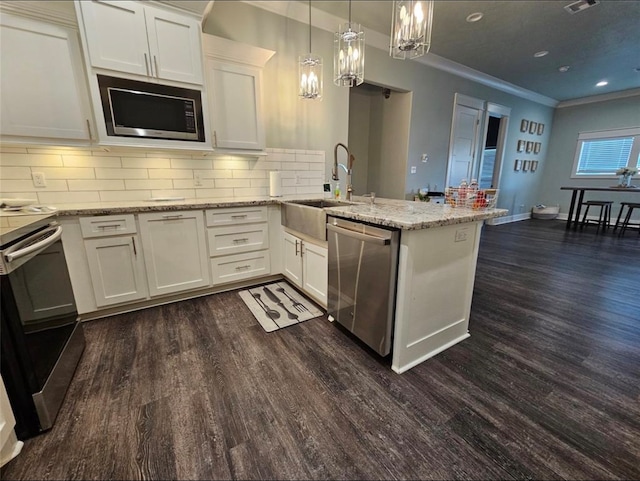 kitchen featuring white cabinets, tasteful backsplash, stainless steel appliances, and dark wood-type flooring