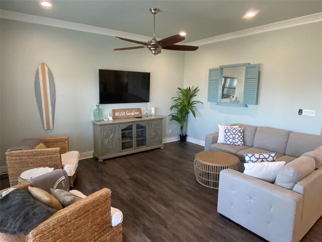 living room with ceiling fan, crown molding, and dark wood-type flooring