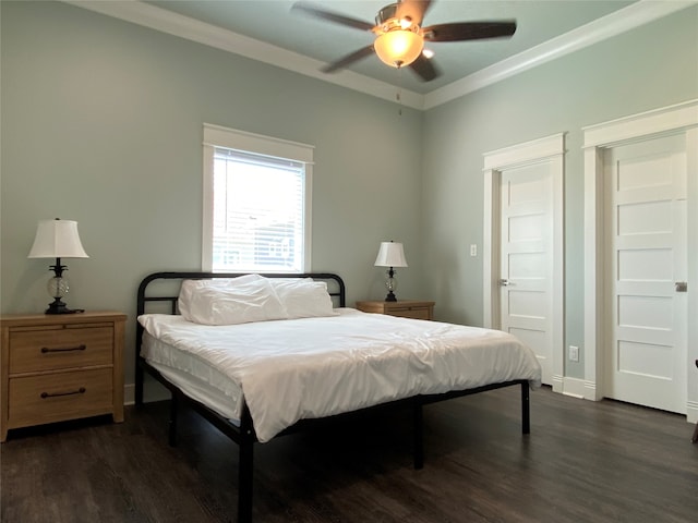 bedroom with ornamental molding, dark hardwood / wood-style flooring, and ceiling fan