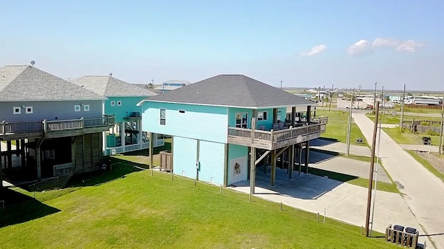 back of property with a yard and a wooden deck