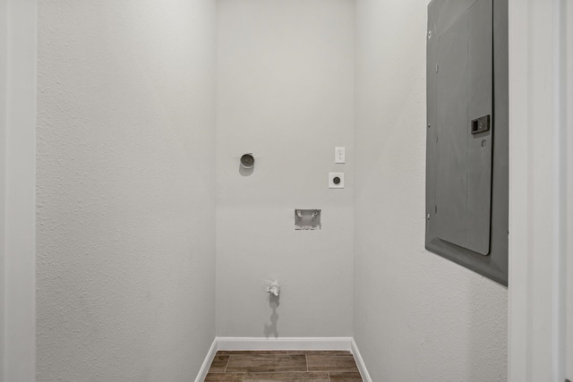 laundry room featuring hardwood / wood-style flooring, electric dryer hookup, hookup for a washing machine, and electric panel