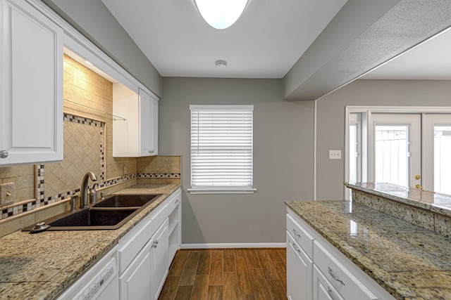 1329 Fountain View Dr Unit 135, Houston, TX 77057 - kitchen with tasteful backsplash, dark hardwood / wood-style flooring, white cabinetry, and sink