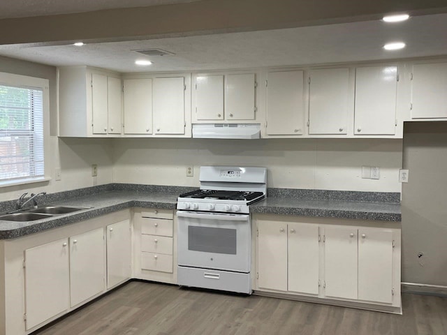 kitchen featuring white cabinets, sink, hardwood / wood-style floors, and white range with gas cooktop