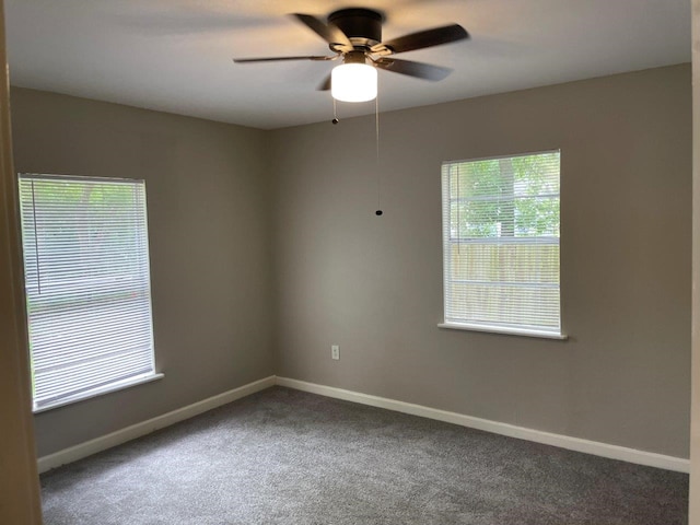 carpeted empty room with a healthy amount of sunlight and ceiling fan