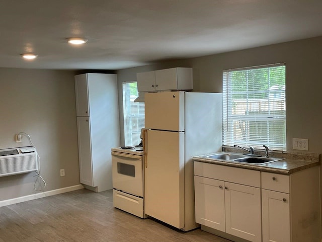 kitchen with a healthy amount of sunlight, white appliances, and white cabinetry