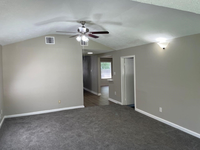 carpeted spare room featuring ceiling fan, a textured ceiling, and vaulted ceiling