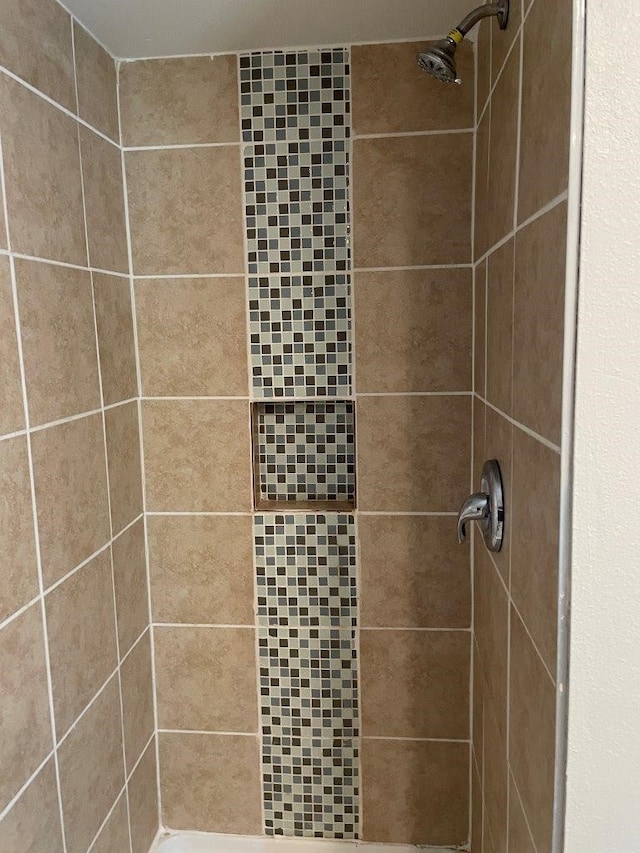 bathroom with a tile shower