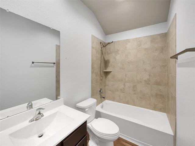 full bathroom with tiled shower / bath, vanity, toilet, and hardwood / wood-style flooring