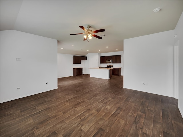 unfurnished living room featuring dark hardwood / wood-style flooring, ceiling fan, and lofted ceiling