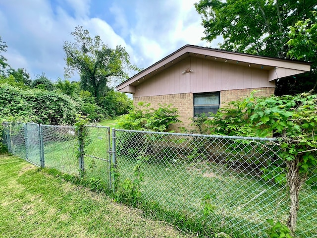 view of side of home featuring a lawn