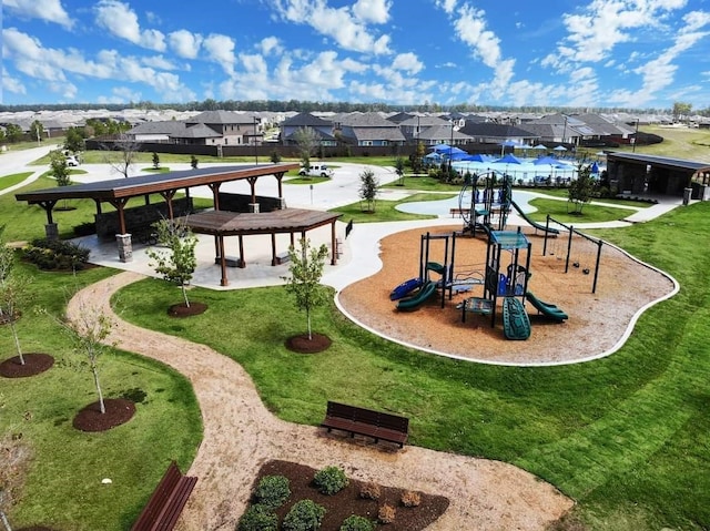 surrounding community featuring a playground and a lawn