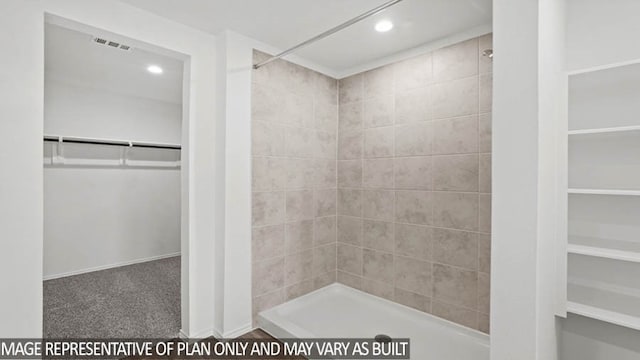 bathroom with tiled shower