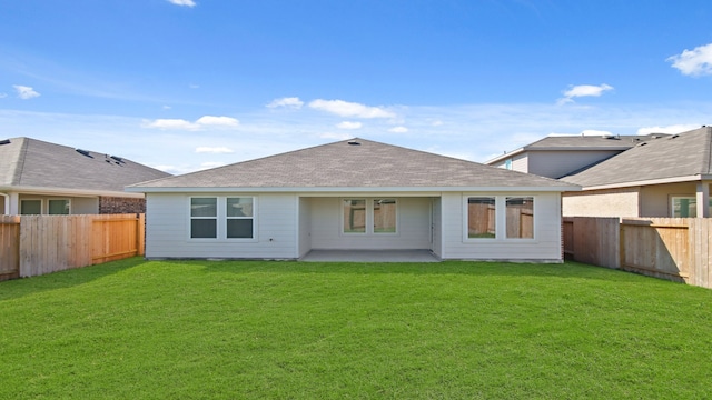 rear view of house with a patio and a lawn