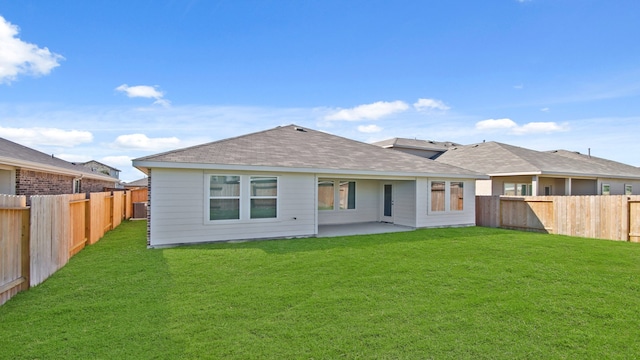 back of house with a yard and a patio