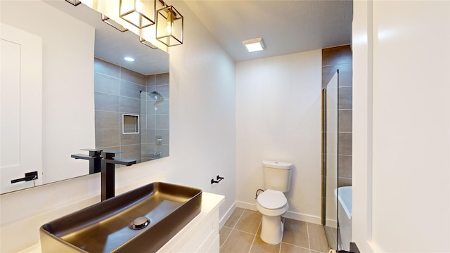 bathroom with tile flooring, large vanity, and toilet