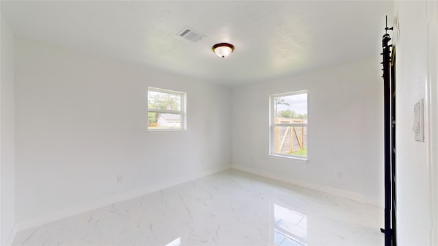 tiled spare room with plenty of natural light