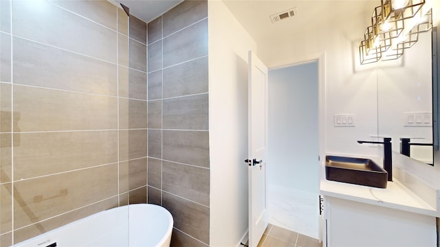 bathroom with tile walls, tile flooring, and vanity