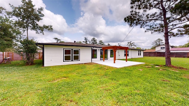 back of house featuring a patio and a lawn