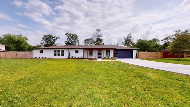 ranch-style home featuring a garage and a front yard