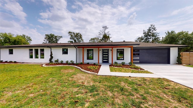 view of front of property with a garage and a front yard