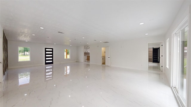 unfurnished room with light tile floors