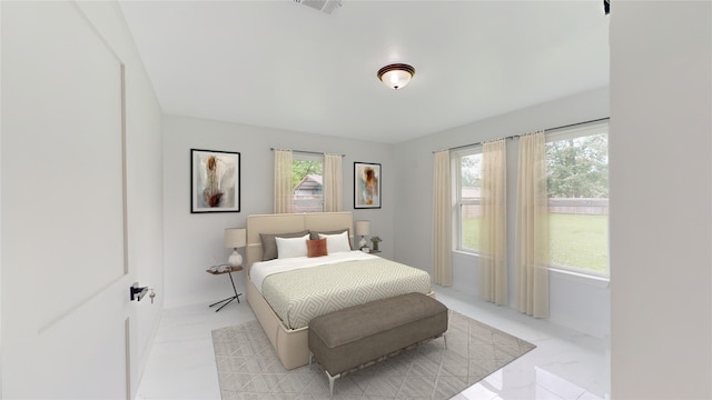 tiled bedroom featuring multiple windows