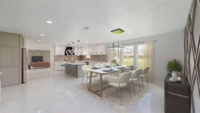 dining room with sink and light tile flooring