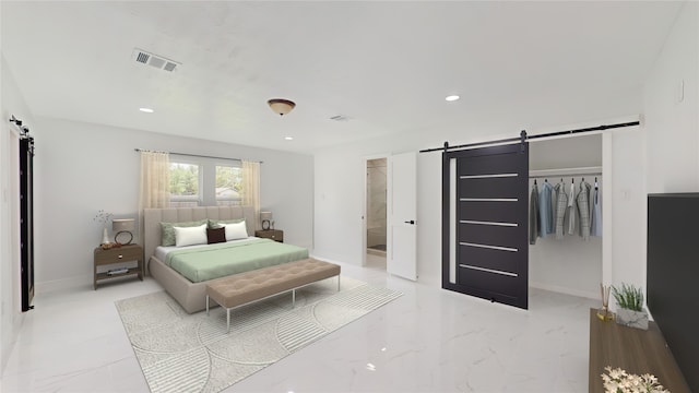 bedroom with a closet, a barn door, and light tile floors