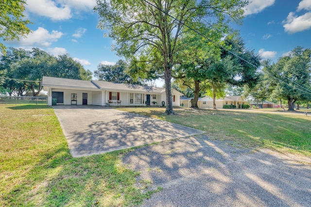 ranch-style home with a front yard and covered porch