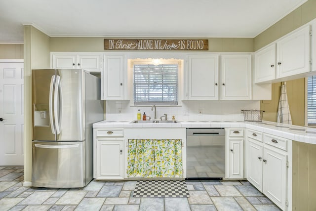 kitchen featuring sink, tile countertops, stainless steel appliances, white cabinets, and decorative backsplash