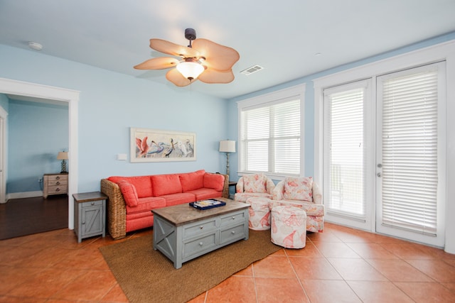 living room featuring ceiling fan and light tile flooring