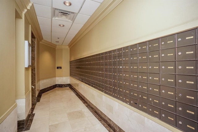 corridor with a mail area, light tile floors, and a drop ceiling