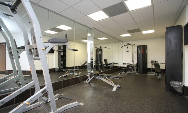 exercise room with a drop ceiling