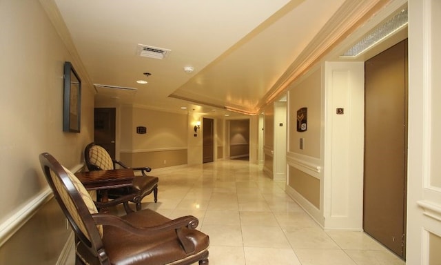 hall featuring ornamental molding and light tile floors