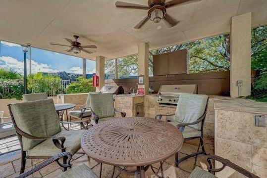 view of patio / terrace with ceiling fan and area for grilling